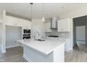 Modern kitchen featuring white cabinetry, quartz countertops and stainless steel appliances at 135 Newport Lndg, Garner, NC 27529