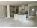 Spacious living room with ample natural light, bare concrete floors, and rough in for kitchen appliances at 136 Malbec Dr, Chapel Hill, NC 27516