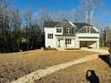 Two story house with gray and white siding, large yard, and mature trees at 115 Pedestal, Zebulon, NC 27597