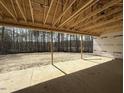 Unfinished outdoor living space with lumber construction and an exposed ceiling set among tall trees at 1275 Cameron Hill Rd, Cameron, NC 28326