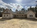 New construction home with a gray roof, covered in house wrap, and set on a large lot with some trees at 1275 Cameron Hill Rd, Cameron, NC 28326