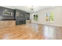 Spacious living room featuring hardwood floors, a fireplace with custom built-ins, and natural light at 14020 Durant Rd, Raleigh, NC 27614