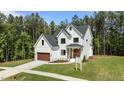 Beautiful new construction features board and batten siding, a charming entryway, and a manicured front lawn at 100 N Ridge View Way, Franklinton, NC 27525