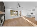 Sunlit living room showcasing an open layout, windows, and seamless flow to the kitchen area at 5300 Pulley Town Rd, Zebulon, NC 27597