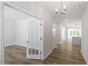 Bright hallway with hardwood floors that guide you to an airy kitchen and living spaces at 119 Augusta Pond Way # 147, Raleigh, NC 27603