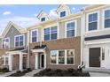 Gray siding townhome exterior with dark brown front door at 207 Chesapeake Commons Street # 80, Garner, NC 27529