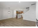 Open concept kitchen with island and hardwood floors at 207 Chesapeake Commons Street # 80, Garner, NC 27529