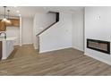Bright living room with fireplace, hardwood floors, and kitchen island view at 207 Chesapeake Commons Street # 80, Garner, NC 27529