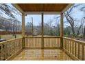 Inviting covered wooden deck with railing and a view of the backyard at 2708 B Ashley St, Durham, NC 27704