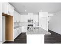 Contemporary kitchen features white cabinets, granite countertops, stainless steel appliances, and a center island at 289 Hank Way, Angier, NC 27501