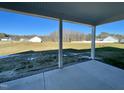 Covered back porch with beautiful views of the home's expansive backyard at 21 Oakbridge Way, Pikeville, NC 27863