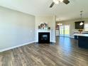 Inviting living room with fireplace, flowing into the kitchen with island and modern features at 21 Oakbridge Way, Pikeville, NC 27863