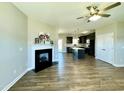 Inviting living room with fireplace, flowing into the kitchen with island and modern features at 21 Oakbridge Way, Pikeville, NC 27863