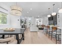 Open-concept living space with hardwood floors seamlessly connects kitchen, dining, and living areas at 227 Woodsborough Pl, Raleigh, NC 27601