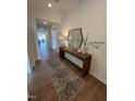 Welcoming entryway features hardwood floors, decorative console table, and stylish mirror, creating an inviting ambiance at 235 Chestnut Oak Ln, Lillington, NC 27546
