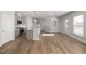 Open-concept living room featuring sleek hardwood floors and modern, neutral paint at 103 W Star Foal Ln, Wendell, NC 27591