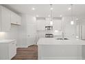 Bright, all-white kitchen with a large center island and modern appliances at 22 Belmont Stakes Ln, Wendell, NC 27591