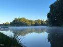 Scenic lakefront property with tranquil water views and lush greenery at 4416 Arrowhead Trl, Hillsborough, NC 27278