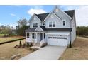 Beautiful two-story home with a two-car garage, well-maintained landscaping, and classic architectural details at 75 E Star Foal Ln, Wendell, NC 27591