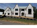 New construction home featuring multiple gables, large windows, and black security fencing at 9105 Overlook Crest Dr, Wake Forest, NC 27587