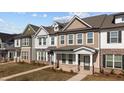 Attractive townhomes showcase varied color palettes, complementary brick accents, and professionally maintained lawns at 953 Alma Railway Dr, Wake Forest, NC 27587