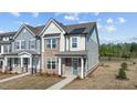 Charming townhome featuring a combination of stone and siding, complemented by a welcoming front porch at 959 Alma Railway Dr, Wake Forest, NC 27587