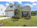Charming one-story house with a covered porch and well-manicured lawn at 71 Nolan Ct, Lillington, NC 27546