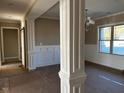 An open-concept entryway with decorative column and trim work, adjacent to a dining area at 981 Olive Branch Dr, Smithfield, NC 27577