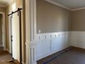 An elegant entryway with decorative column and trim work, featuring a stylish sliding barn door at 981 Olive Branch Dr, Smithfield, NC 27577
