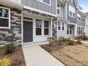 Townhome's front entrance with stone and gray siding at 448 La Maison Ave # 19, Wendell, NC 27591