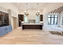 Spacious kitchen featuring a center island, white cabinets, and stainless steel appliances at 7208 Tanbark Way, Raleigh, NC 27615