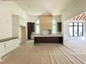 Open concept kitchen featuring custom cabinetry, large island, and ample natural light at 7208 Tanbark Way, Raleigh, NC 27615