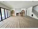Spacious living room with large windows, fireplace, and built-in shelving ready for finishing touches at 7208 Tanbark Way, Raleigh, NC 27615
