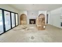 Spacious living room with a tiled fireplace, built-in shelves, and large sliding glass doors at 7208 Tanbark Way, Raleigh, NC 27615