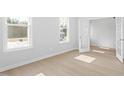 Sunlit bedroom featuring hardwood floors, neutral paint and bright windows at 100 Bold Dr, Youngsville, NC 27596