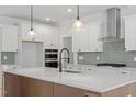 Modern kitchen featuring white cabinets, stainless steel appliances, and center island at 100 Bold Dr, Youngsville, NC 27596