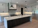 Bright kitchen featuring modern cabinetry, an expansive island, and stainless steel appliances at 126 Harvest Ln, Pittsboro, NC 27312