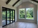 Sun-filled living room boasting hardwood floors, vaulted ceilings, and beautiful backyard views at 126 Harvest Ln, Pittsboro, NC 27312