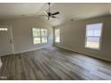 Inviting living room featuring a ceiling fan, plenty of natural light, and neutral paint at 247 Jenkins St, Erwin, NC 28334