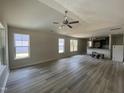 Bright and spacious living room with vaulted ceilings, modern flooring, and large windows at 247 Jenkins St, Erwin, NC 28334