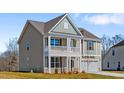 Inviting two-story house with a front porch and a two-car garage, set on a well-maintained lawn at 2820 Lacy Holt Rd, Graham, NC 27253