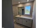 Modern bathroom featuring glass shower, white vanity with quartz countertop, and large mirror at 1341 Bessie Ct, Wake Forest, NC 27587