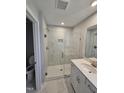 Modern bathroom featuring glass shower with white marble tile and white vanity with quartz countertop at 1341 Bessie Ct, Wake Forest, NC 27587