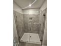 Bathroom featuring a large glass shower with gray tile surround and recessed niche at 1345 Bessie Ct, Wake Forest, NC 27587