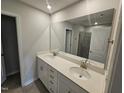 Bathroom with double sink vanity, quartz countertop and an oversized mirror at 1345 Bessie Ct, Wake Forest, NC 27587