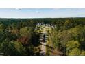 An aerial view of a beautifully designed neighborhood surrounded by lush greenery and mature trees at 4905 Foxridge Dr, Raleigh, NC 27614
