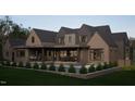 Beautiful backyard featuring an outdoor kitchen, seating area, and lush landscaping, perfect for entertaining at 4905 Foxridge Dr, Raleigh, NC 27614