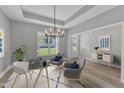 Bright office space with a modern chandelier, comfortable seating, and plenty of natural light at 119 Water Ave, Wake Forest, NC 27587