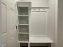 Organized mudroom featuring white built-in shelving, bench, and hooks for storage and convenience at 484 Traditions Grande Blvd # 29, Wake Forest, NC 27587