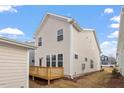 View of the back of the home and wooden deck overlooking a spacious backyard at 9237 Kitchin Farms Way # 429, Wake Forest, NC 27587